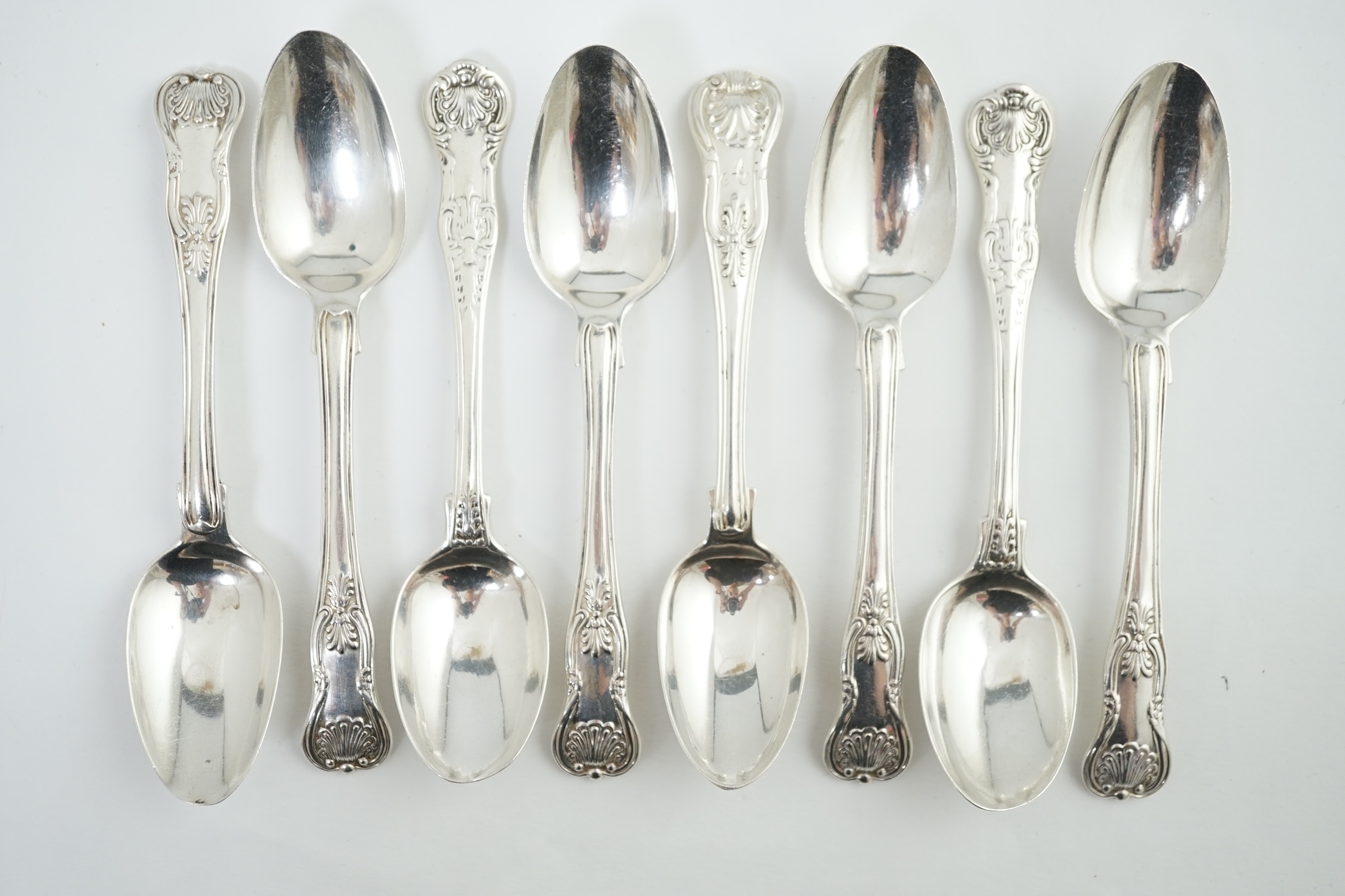 A harlequin set of eight Georgian and Victorian silver Kings pattern teaspoons, various dates and makers